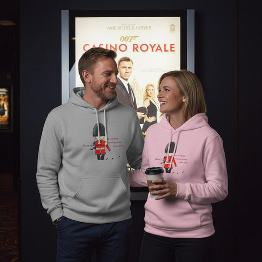 Two people wearing hoodies of an English guardsman design with a 'Casino Royale' movie poster in the background