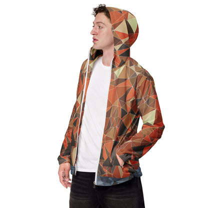 Person wearing a multicolor geometric patterned windbreaker jacket on a white background